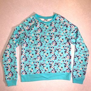 Light blue girl’s sweater with printed flowers